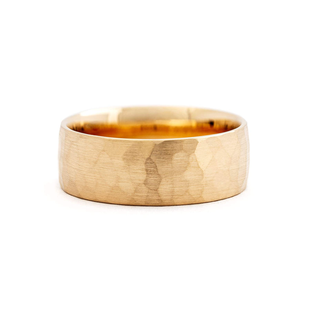 Hand-hammered surface in the 8mm wide men's ring made in 18K yellow gold by Au3 Goldsmiths