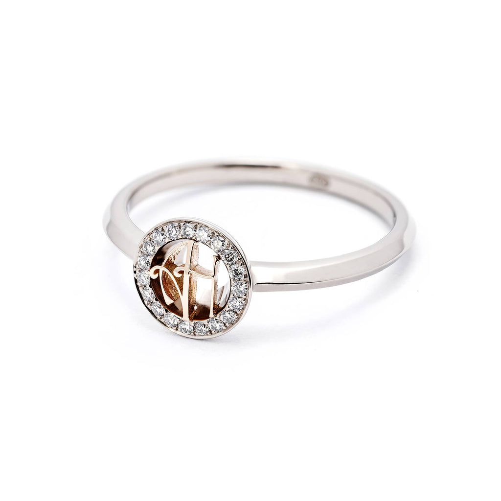 Grammi ring: round monogram with two letters made in 750 yellow gold in the middle, circle of diamonds around the monogram. Material of the ring 750 white gold. Finalist of the Most beautiful ring of the year 2021. Design Tero Hannonen, Au3 Goldsmiths. 