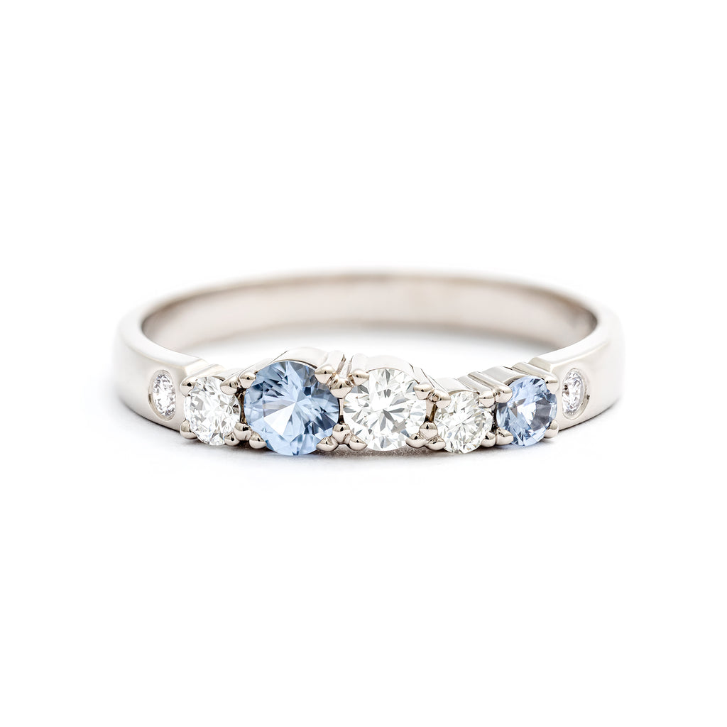 Pastel blue sapphires and white tw/vs diamonds a the 2,5mm wide keto Meadow ring made in 18K white gold. Design by Jussi Louesalmi, Au3 Godlsmiths.