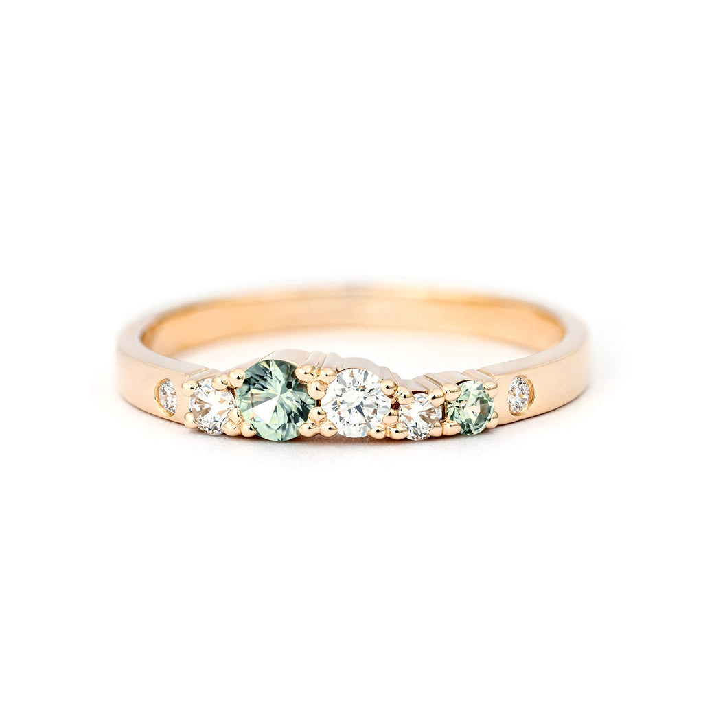Pastel green sapphires and white tw/vs diamonds in a slender Keto Meadow spring collections ring in 750 yellow gold. Design by Jussi Louesalmi, Au3 Goldsmiths.