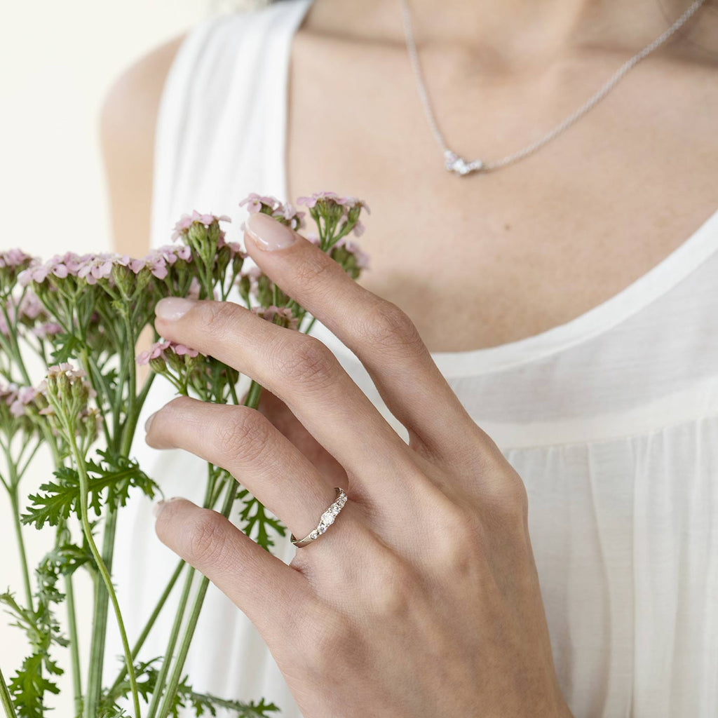 2mm wide Keto Meadow diamond ring on a models finger. Design by Jussi Louesalmi, Au3 Goldsmiths.