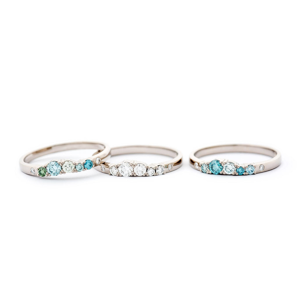 Three 2mm wide Keto Meadow rings with turquoise, green and white diamonds, made in 750 white gold or 950 platinum. Design by Jussi Louesalmi, Au3 Goldsmiths.