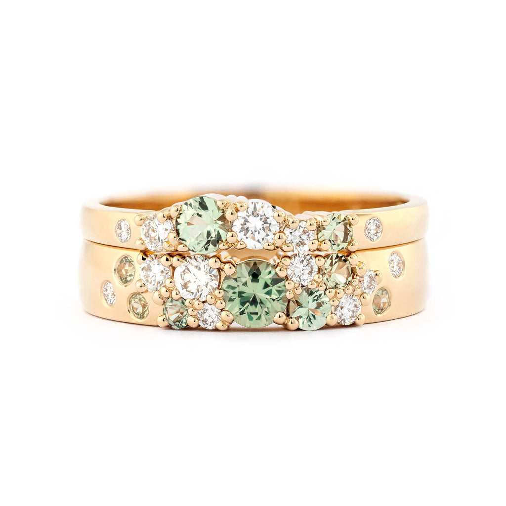 Keto Meadow 4mm and 2mm wide Spring collection's rings in 750 yellow gold, with pastel green sapphires and white tw/vs diamonds.  Design by Jussi Louesalmi, Au3 Goldsmiths.