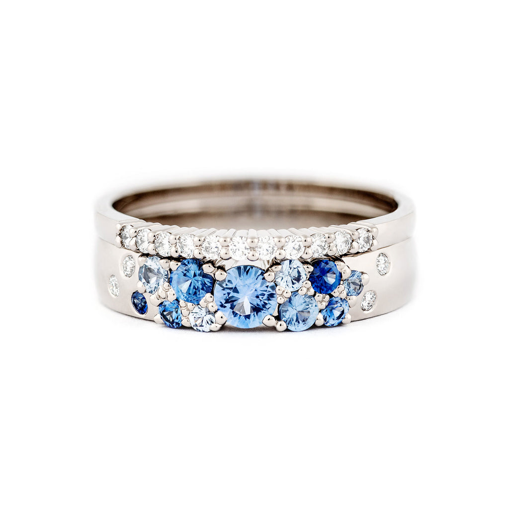 Keto Meadow 4mm wide ring, with blue sapphires and white diamonds together with 1,5mm raita ring with white diamonds. Both rings are made in 750 white gold. Design by Jussi Louesalmi Au3 Goldsmiths.