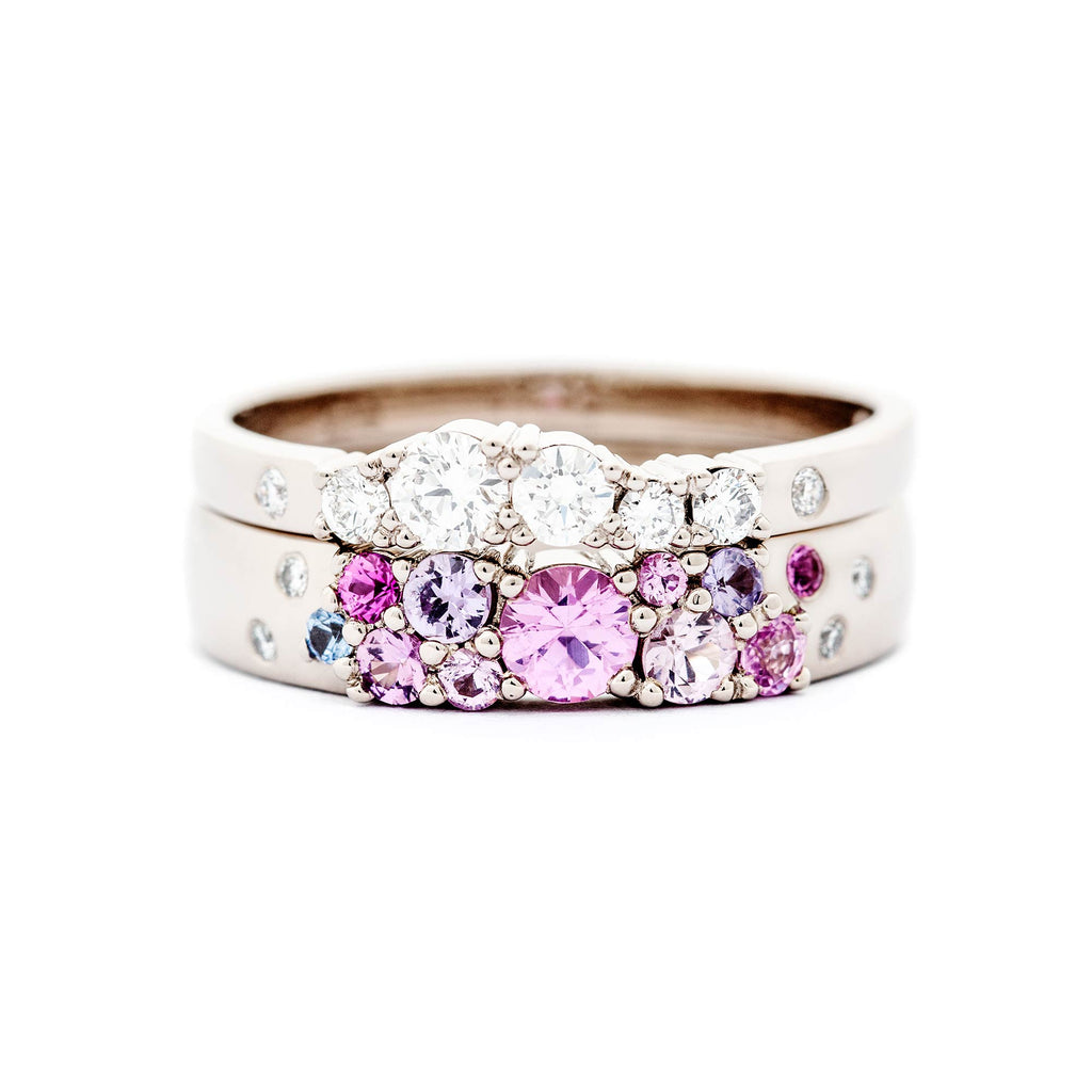 2mm wide Keto Meadow ring with white diamonds, and 4mm wide Keto Meadow ring with pink, violet and blue sapphires and white diamonds. Design by Jussi Louesalmi, Au3 Goldsmiths.