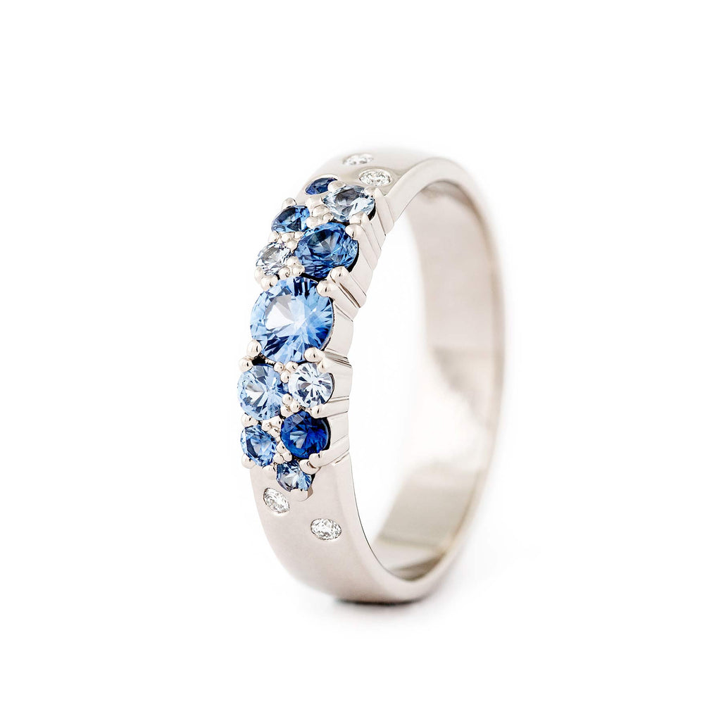 Keto Meadow 4mm wide ring in 750 white gold, with blue sapphires and white diamonds. Design by Jussi Louesalmi Au3 Goldsmiths.