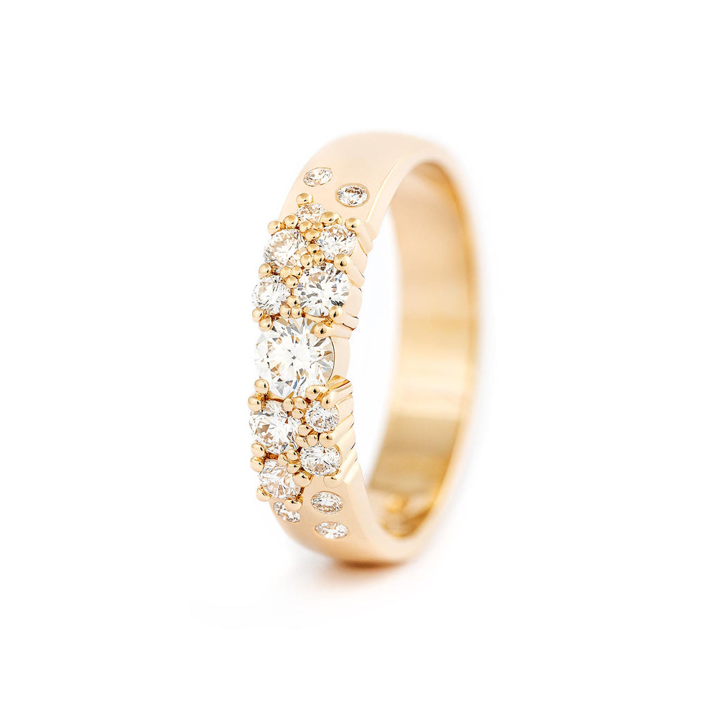 Keto Meadow ring in glowing yellow gold. White diamonds are placed asymmetrically. Design by Jussi Louesalmi, Au3 Goldsmiths. 