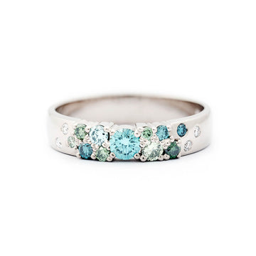 Keto Meadow 4mm wide ring in 750 white gold, with turquoise and green diamonds and white tw/vs diamonds. Design by Jussi Louesalmi, Au3 Goldsmiths.