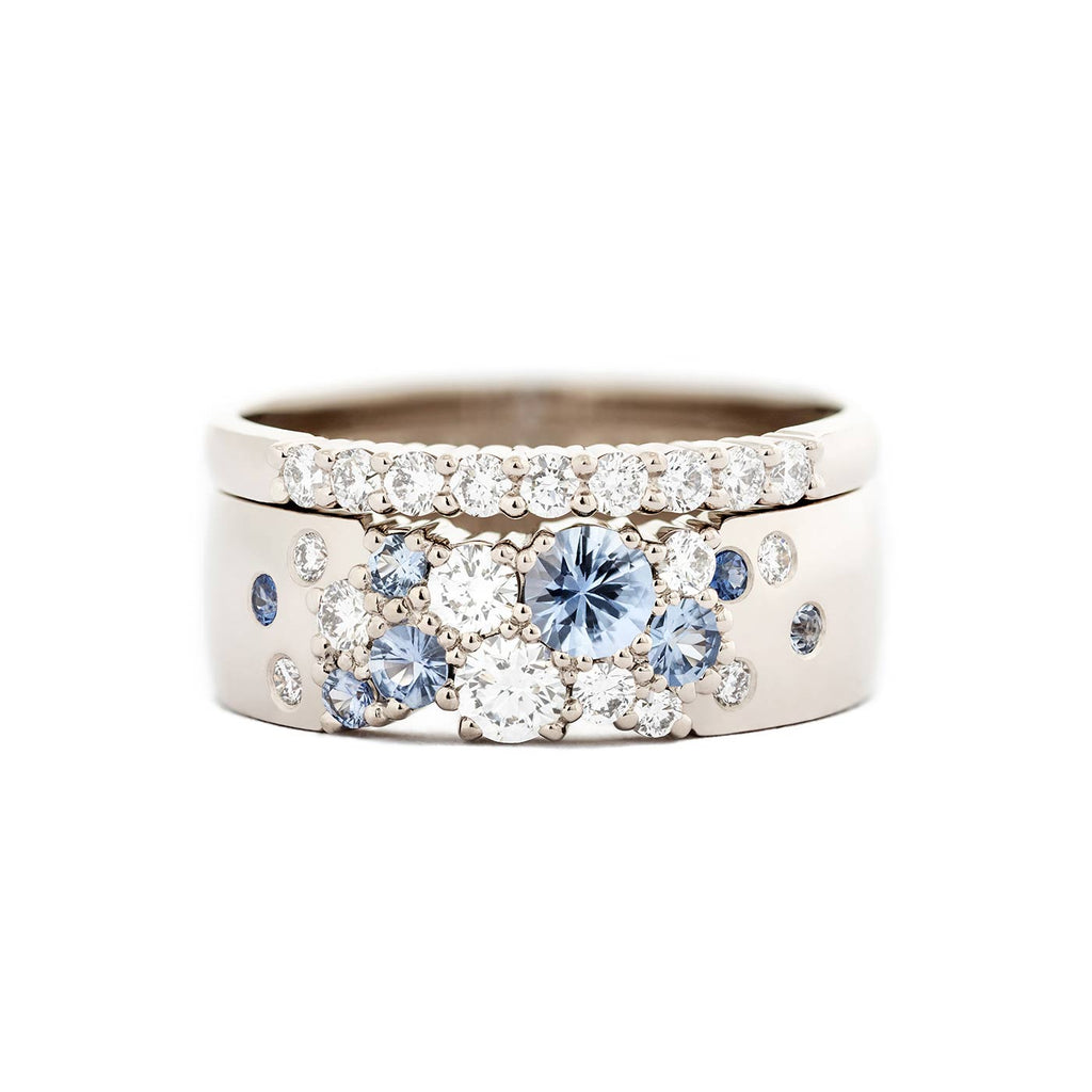 Keto Meadow Spring collection's 6mm wide ring with pastel blue sapphires and white tw/vs diamonds together with Raita 1,5mm wide ring with white tw/vs diamonds. Both rings are made in 750 white gold. Design by Jussi Louesalmi, Au3 Goldsmiths.