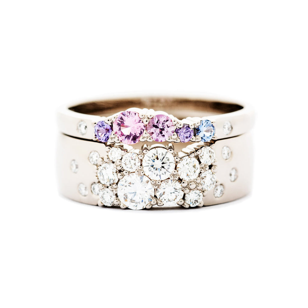 Combination of 6mm wide Keto Meadow ring with white diamonds, and 2mm wide Keto Meadow ring with pink, violet and blue sapphires and white diamonds. Design by Jussi Louesalmi, Au3 Goldsmiths.