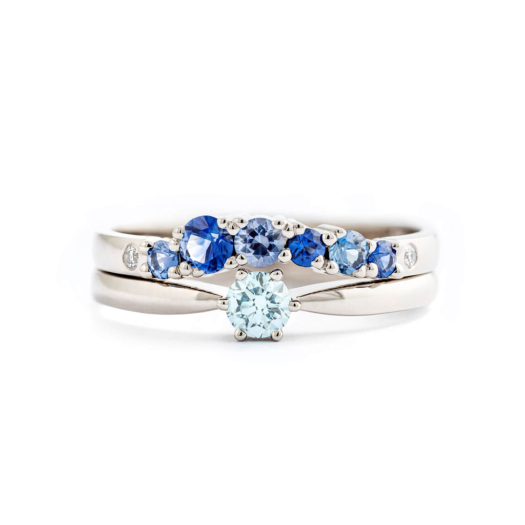 Keto Meadow One solitaire ring with turquoise Ice Blue diamond, together with Keto Meadow Arc blue ring with blue sapphires and white tw/vs diamonds. Design by Jussi Louesalmi, Au3 Goldsmiths.