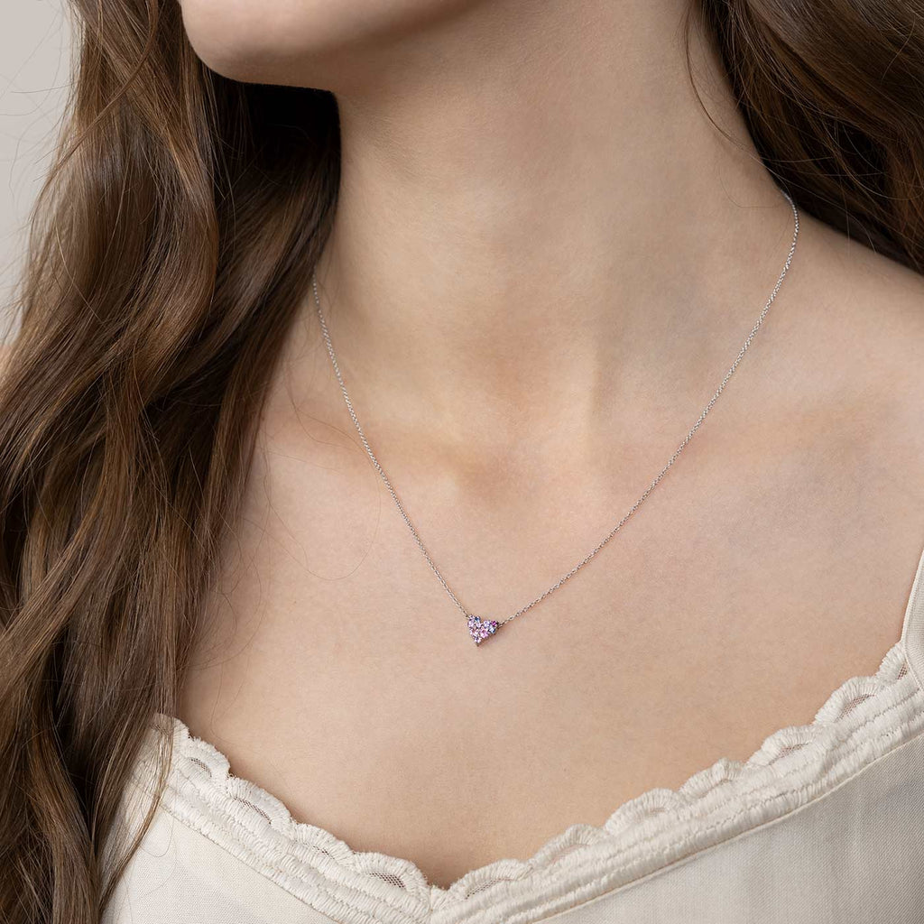 Model wearing a Keto Meadow Pink Heart S necklace, which has different color saphhires in pink, blue and violet. Design by Jussi Louesalmi, Au3 Goldsmiths.