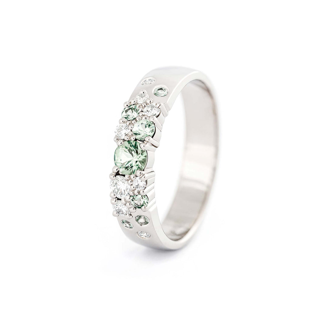 Keto Meadow 4mm wide Spring collection's rings in 750 white gold, with pastel green sapphires and white tw/vs diamonds. Design by Jussi Louesalmi, Au3 Goldsmiths.