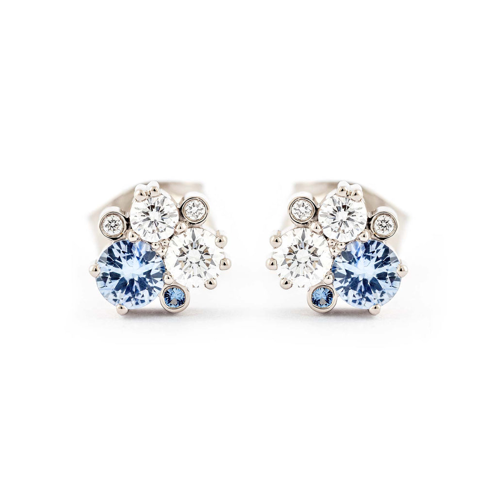 Keto Meadow stud earrings with different size pastel blue sapphires and white tw/vs diamonds. Design by Jussi Louesalmi, Au3 Goldsmiths.