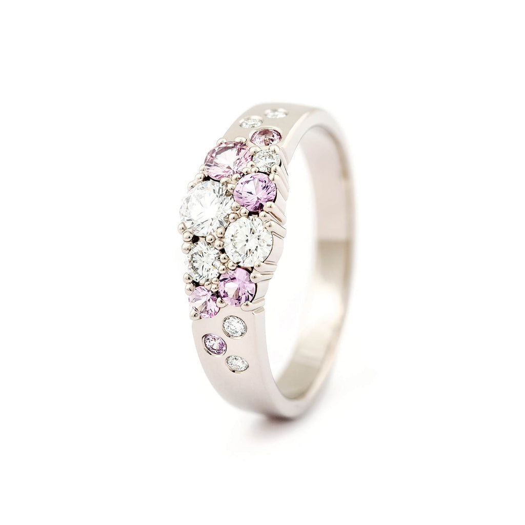 Pastel pink sapphires and white diamonds in the narrowing ring model in the Keto Meadow jewelry collection, design by Jussi Louesalmi, Au3 Goldsmiths.