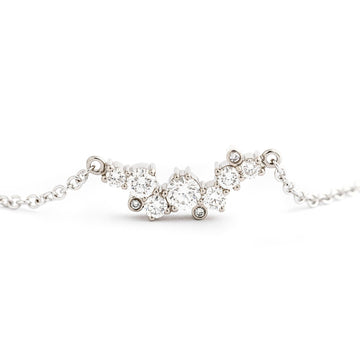 Asymmetrically placed different size white diamonds in a Keto Meadow Crown necklace. Design by Jussi Louesalmi, Au3 Goldsmiths.