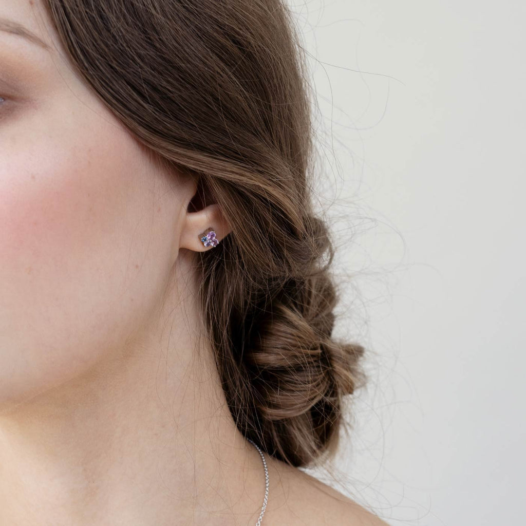 Model wearing Keto Meadow earrings with 4 colorful sapphires, design by Jussi Louesalmi, Au3 Goldsmiths.