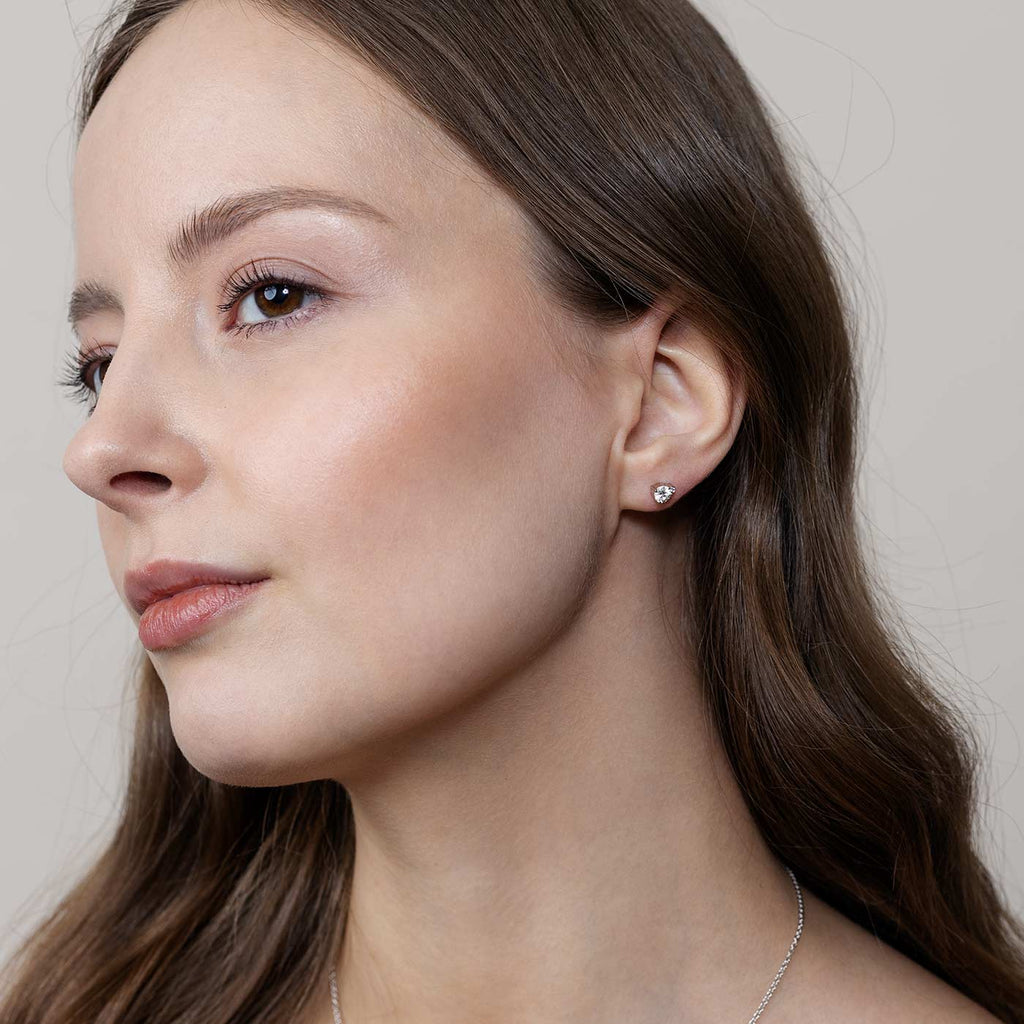 Model wearing Keto Meadow diamond earrings, design by Jussi Louesalmi, Au3 Goldsmiths