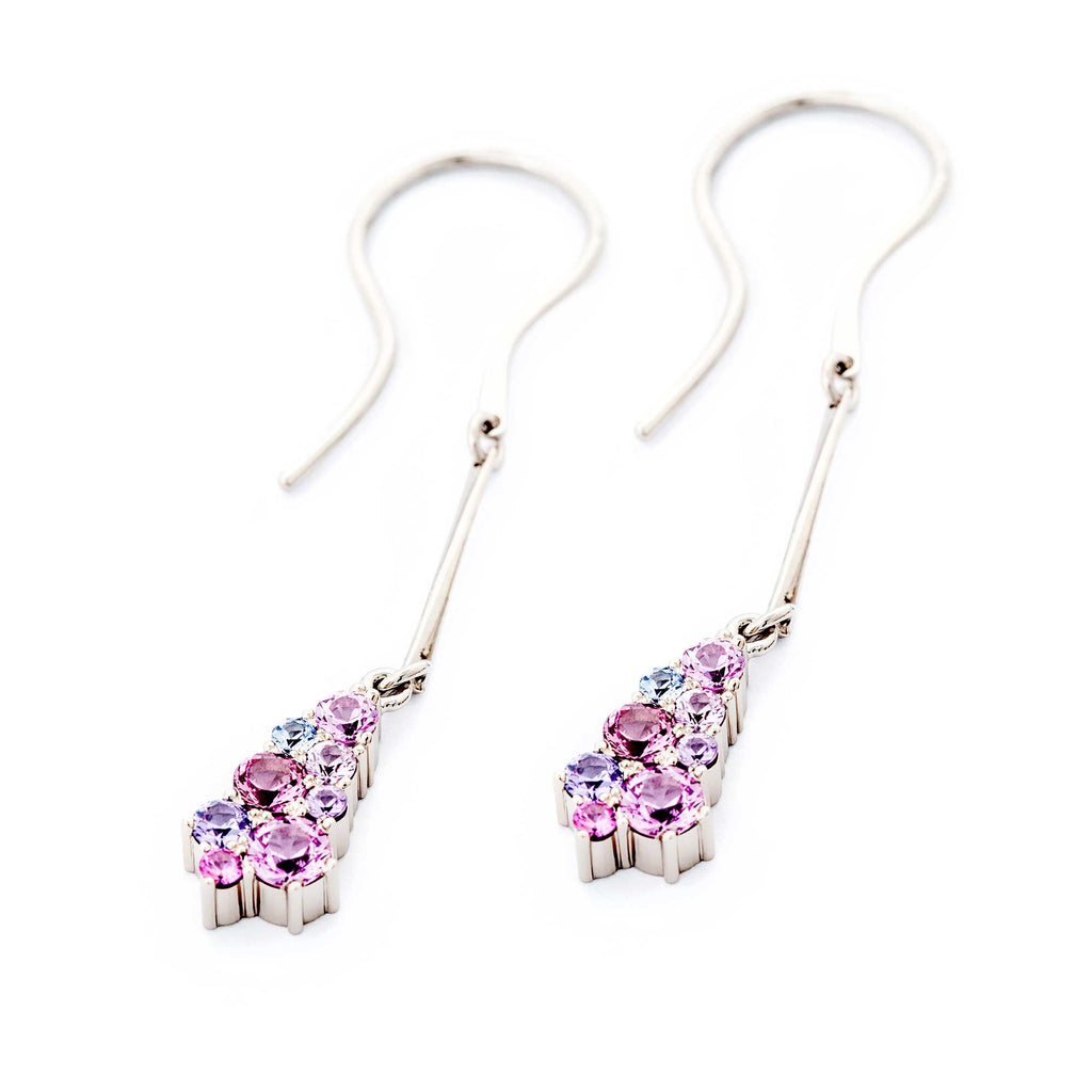 A pair of hanging drop shaped earrings, with pink, violet and blue sapphires. Design by Jussi Louesalmi, Au3 Goldsmiths.
