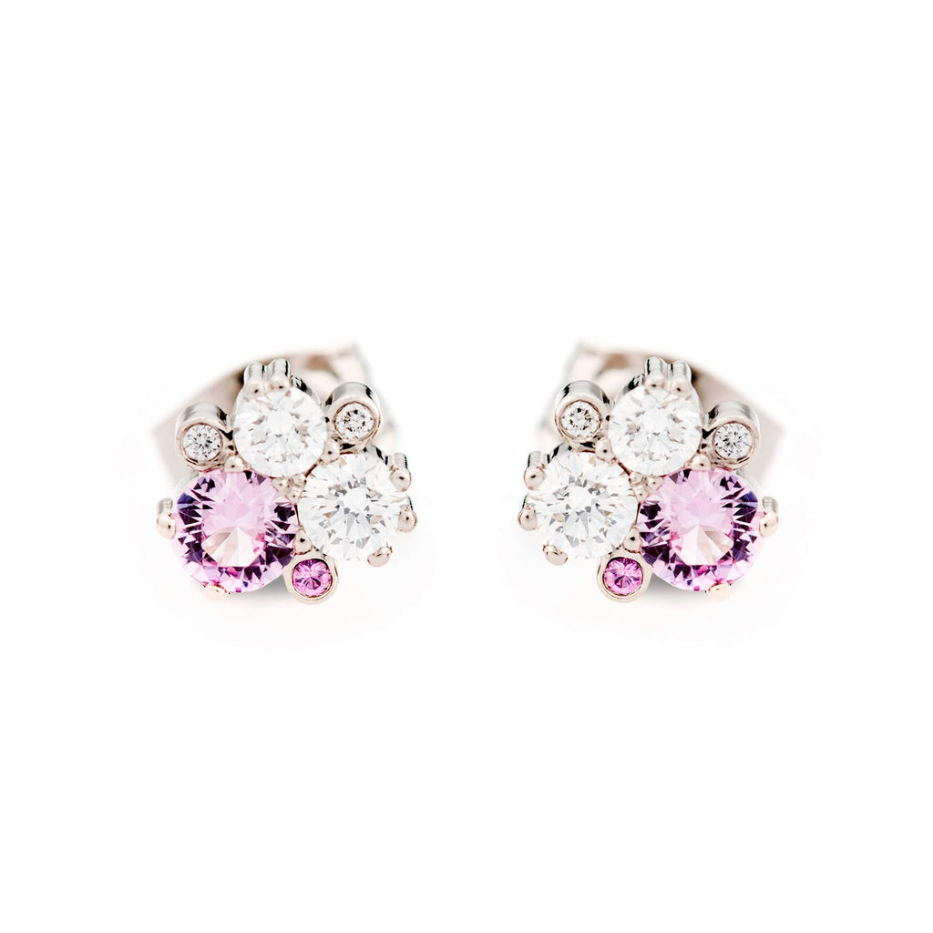 A pair of Keto Meadow stud earrings with pastel pink sapphires and white tw/vs diamonds placed asymmetrically. Deign by Jussi Louesalmi, Au3 Goldsmiths.