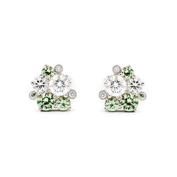 Different size pastel green sapphires and white diamonds in Keto Meadow Spring collection's stud earrings, design by Jussi Louesalmi, Au3 Goldsmiths.
