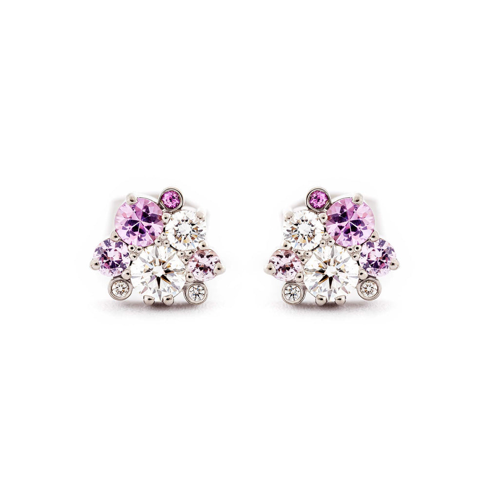 Stud earrings with different size pink sapphires and white tw/vs diamond placed asymmetrically in a cluster. Design by Jussi Louesalmi, Au3 Goldsmiths.