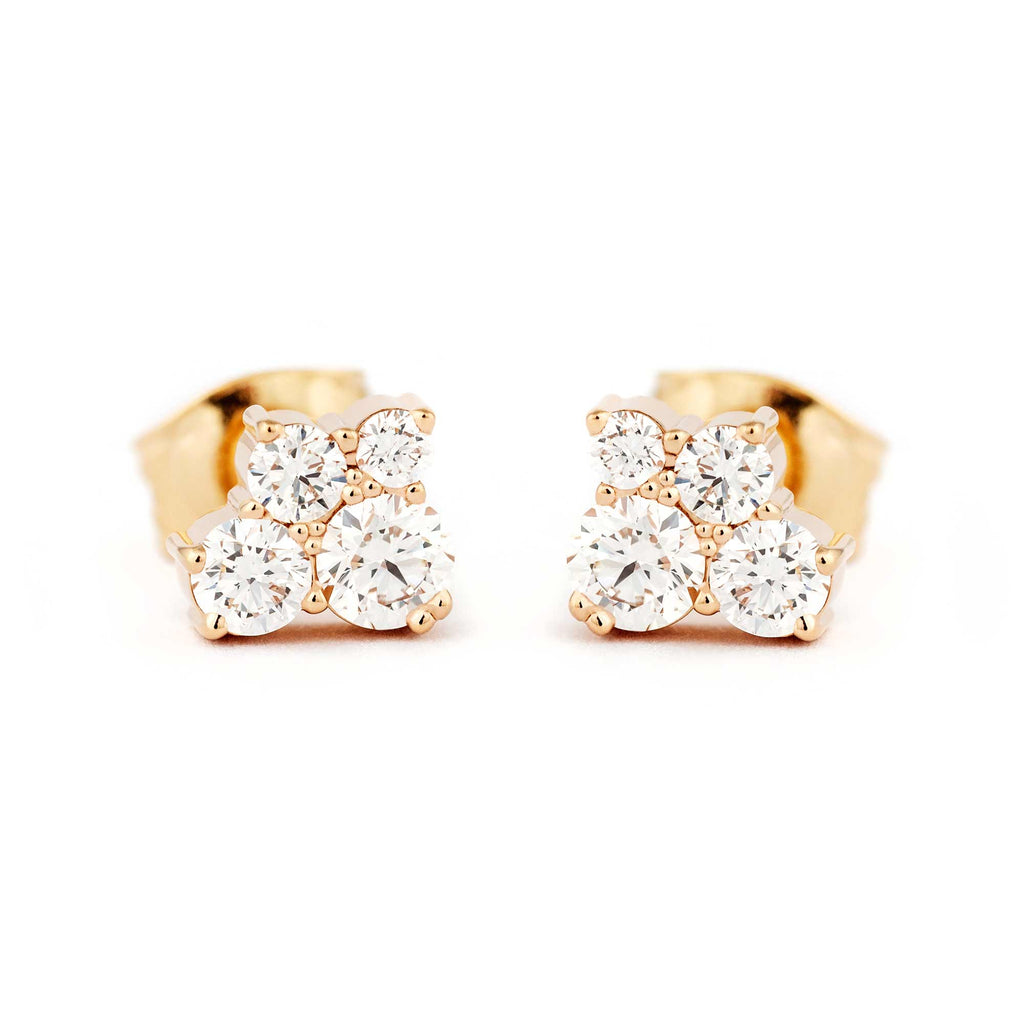 A pair of Keto Meadow stud earrings both with 4 white different size diamonds. Design by Jussi Louesalmi, Au3 Goldsmiths.