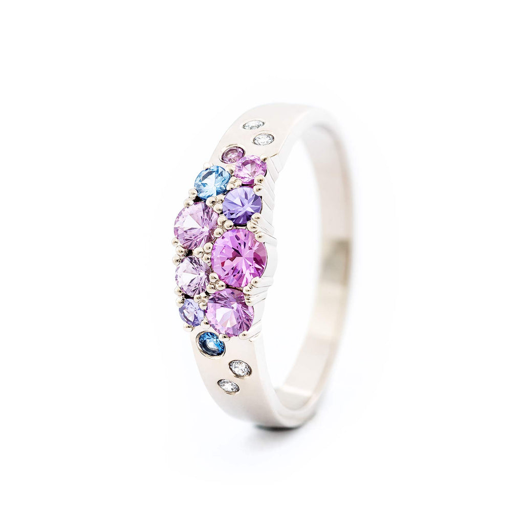 Keto Meadow narrowing ring with pink, blue and violet sapphires and white diamonds. Design by Jussi Louesalmi, Au3 Goldsmiths.
