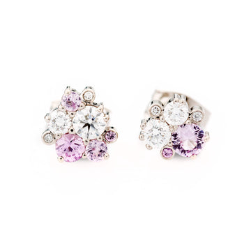 An asymmetrical pair of Keto Meadow stud earrings with pastel pink sapphires and white diamonds. Design by Jussi Louesalmi, Au3 Goldsmiths.