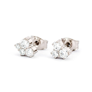 Keto Meadow stud earrings with 4 and 3 white diamonds. Design by Jussi Louesalmi, Au3 Goldsmiths.