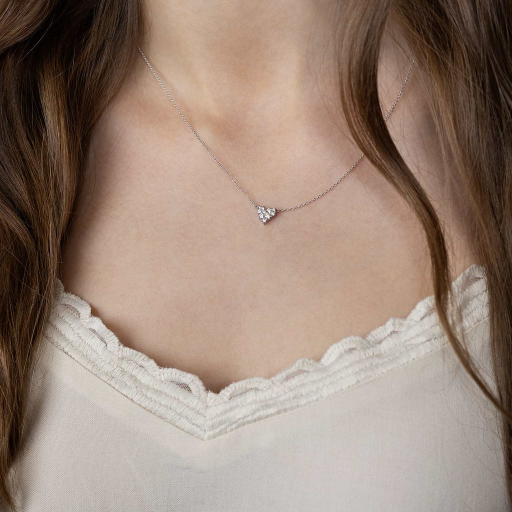Model wearing a small Keto Meadow Heart necklace with white diamonds, design by Jussi Louesalmi, Au3 Goldsmiths.