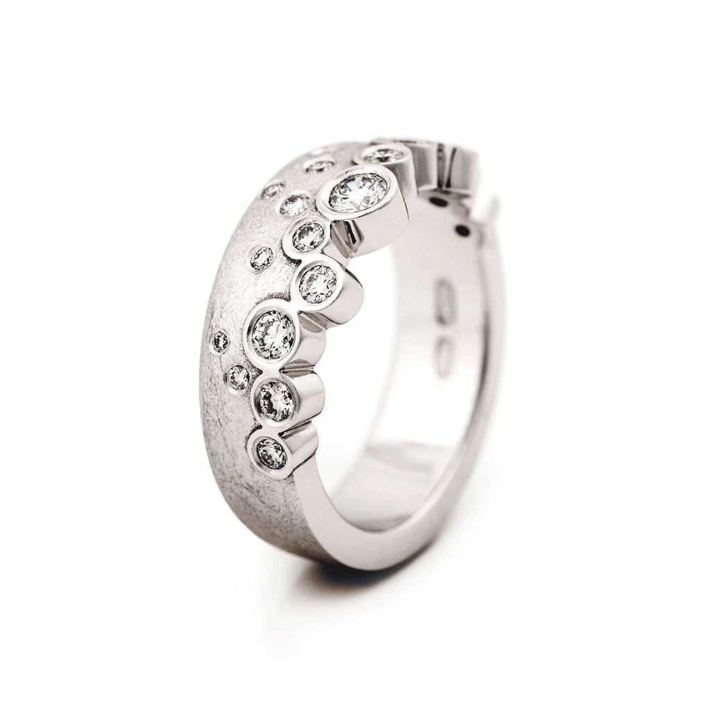i! ring has different size diamonds placed asymmetrically to the wide 750 white gold ring, design Jussi Louesalmi, Au3 Goldsmiths